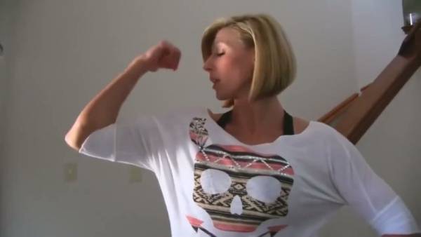 Muscular blonde MILF flexes and flashes huge fake tits during solo webcam show on adultfans.net