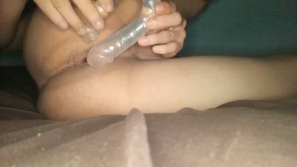 A man slowly works a dildo into his tight anus on a bed on adultfans.net